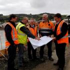 Inspecting the plans for the new Materials Recovery Facility in Green Island are (from left)...