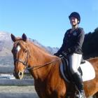 International riding instructor Suzanne Kolff sits next to the round pen used for horsemanship...