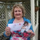 Invercargill crafter Ann-Marie Searle holds up the card sent on behalf of the Duke and Duchess of...