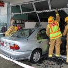 Invercargill firefighters check out the frontage of the book  exchange shop in the Glengarry...