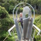 Invercargill MP Eric Roy inspects a possum-proof gate fitted to a bridge over the Waitutu River....