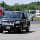 Investigators from the State Fire Marshal's Office leave the scene of the crash at Hanscom Field...