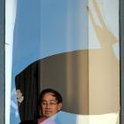 Investment House owner Tony Tan inspects a broken window. Photo by Peter McIntosh
