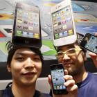 iPhone fans Mitsuru Endo (left) and Ryota Musha show the Apple's latest iPhone 4 during its...