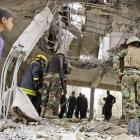 Iraqi security forces inspect the scene where a blast killed seven people in the Hurriya...