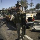 Iraqi security forces stand guard at the site of a bomb attack in Kerbala, 110km south of Baghdad...
