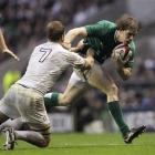 Ireland's' Andrew Trimble, right, is tackled by England's Chris Robshaw during their Six Nations...
