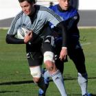 Isaac Ross, left, held by Luke McAlister at the All Blacks rugby training, as they prepare for...