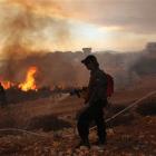 Israeli firefighters tackle a wildfire in the Carmel Heights near Haifa, northern Israel. (AP...