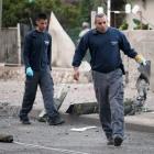 Israeli sappers remove remnants of an exploded rocket fired by Palestinian militants from Gaza at...