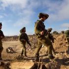 Israeli soldiers walk during training close to the ceasefire line between Israel and Syria on the...