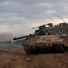 Israeli troops are seen next to the Israeli Gaza border. Photo Dan Balilty/AP.