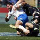 Italy's Robert Barbieri, left, is tackled by Scotland' s Ross Rennie and David Tenton (top)...