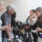 Jacqui Murphy (left), of Central Otago, discusses wine with Angela Bates, of Dunedin, during the...