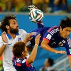 Japan's Atsuto Uchida (R) is fouled by Greece's Giorgios Samaras (L) during their match at the...
