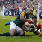 Japan's Karne Hesketh dives over to score the match-winning try against South Africa. Photo Reuters