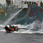 Japanese whaling vessel Yushin Maru No. 2 shoots its water cannons at the Sea Shepherd crew on a...