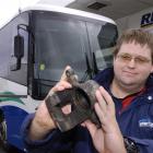 Jared Vercoe holds the brake caliper that came flying through the window of the coach he was...