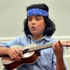 Jayden Jesudhass teaches the ukulele to an attentive class at Toitu Otago Settlers Museum yesterday.