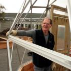Jeff Copson helps build  a bio-dome he designed for  the South Dunedin Community Garden. His son...