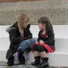 Jessie May White (5), of Makarora, explains Anzac Day to new friend Samantha Varcoe (3), of...