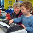 Jill Hulm, of Mosgiel, introduces her grandson Otis Jorgensen (6) to an old-fashioned manual...