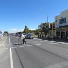 Jim Fraser, with his walking frame, uses the Oamaru north end pedestrian crossing on Thames St...