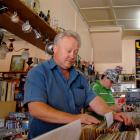 Jim Lloyd flicks through a lifetime's collection of second-hand records at his antiques store in...