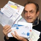 John Alderman (85) holds some of the scam mail he gets daily in his South Dunedin letterbox....