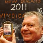 John Evans holds a bottle of 16-year-old single malt whisky which has been labelled Vindication....