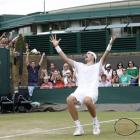 John Isner of the US reacts as he defeats France's Nicolas Mahut, in their epic men's singles...