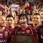 Johnathan Thurston (C) and Queensland teammates celebrate beating New South Wales at ANZ Stadium...
