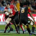 Jono Lance is tackled by Craig Clarke in tonight's Super Rugby match at Waikato Stadium, Hamilton...