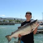 Jordan Pearson, of Berwick, shows off the big salmon he caught from Birch St wharf in Dunedin on ...