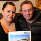 Joselle Tahana and Tim Greene with a photo of their new home in Brockville. Photo by Craig Baxter.