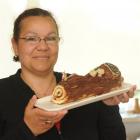 Joyeux Noël! Christiane Leurquin holds a yule log she has made. Photo by Peter McIntosh.