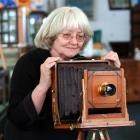 Jude Ferguson from Hayward's Auction House with a Dunedin-made 19th-century plate camera up for...