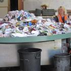 Julie Mitchell and Mick Goldie sort  recyclables on the new revolving sorting table at the...