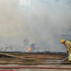 Kaihiku volunteer firefighters put out a fire in a closed timber yard in Kaihiku, near Clinton,...