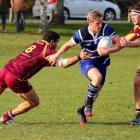 Kaikorai halfback Josh Renton runes through the tackles of Alhambra Union No 8 Ben Pereira and...