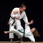 Karate black belt and physicist Emily Hall (standing) gives Queen's High School pupil Suzanne...