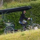Kari Clifford uses her rickshaw’s electric motor to climb a hill in Port Chalmers yesterday....