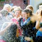 Katie Rademaker hoses mud off fellow Selwyn students after the college's annual Leith run on...