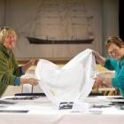 Kay Lang (left) and Barbara Nind prepare a table for a dinner celebrating the 175th anniversary...