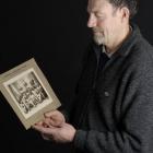 Dunedin runner Keith Johnstone holds the photo of the Dunedin team that won the Edmond Cup in...