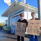 Kelly Cadogan (left), and Linda Forbes continue with their protest outside an Oamaru dairy...