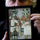 Kevin Hayward displays a pair of Zuni inlaid figurines, part of an online auction of North...