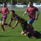 Kia Toa Tigers halfback Joseph Wrathal gets the ball away in the tackle of East Coast Eagles...
