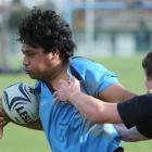 King's High School No 8 Junior Faa'vae attempts to break the tackle of Waitaki Boys' High School...