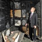 King's High School rector Dan Reddiex examines the fire-damaged gymnasium yesterday. Photo by...